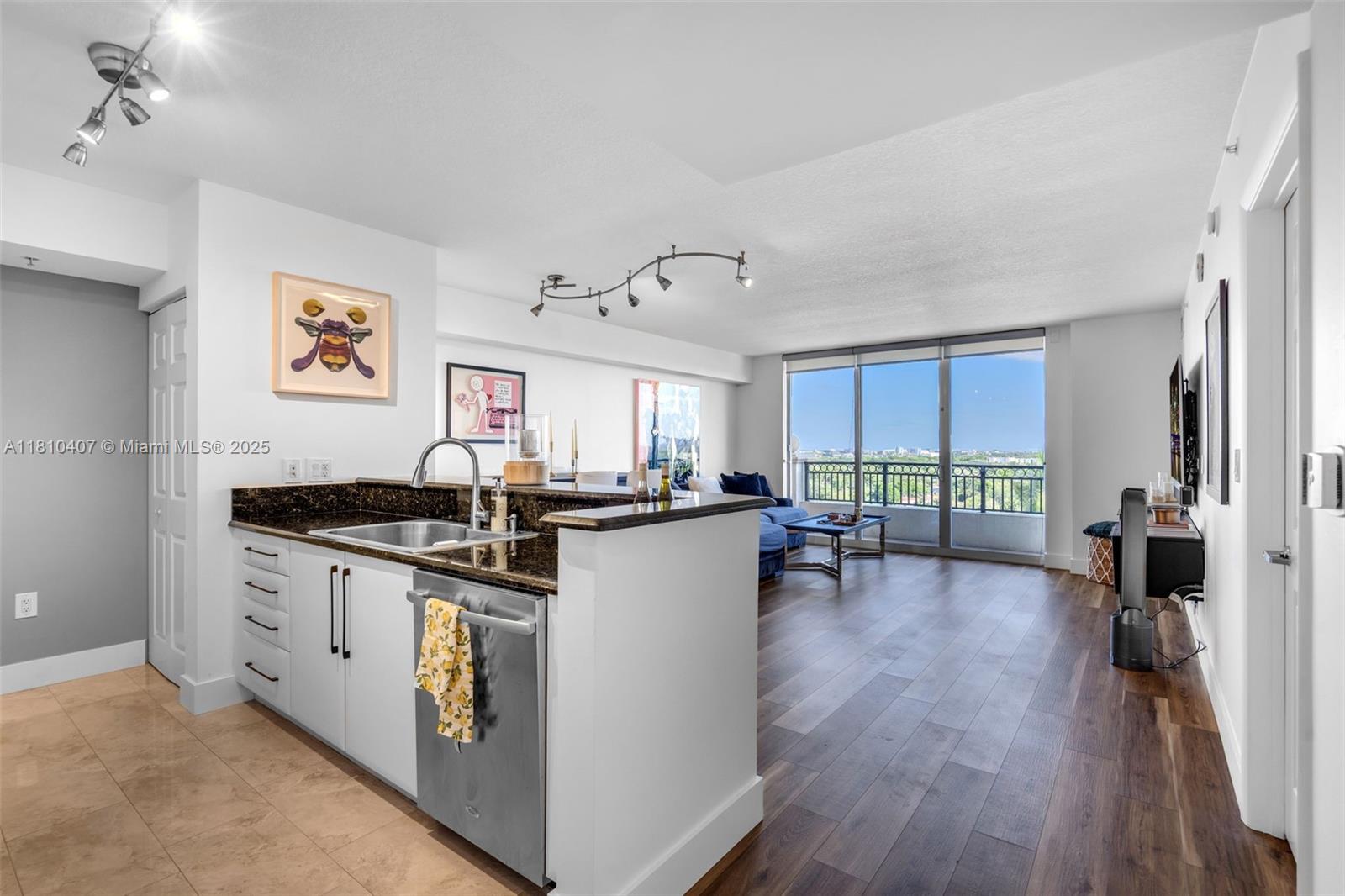 3232 Southwest 22nd Terrace, Unit 1106 Miami, FL 33145 - Photo 4 of 22 a kitchen with sink cabinets and wooden floor
