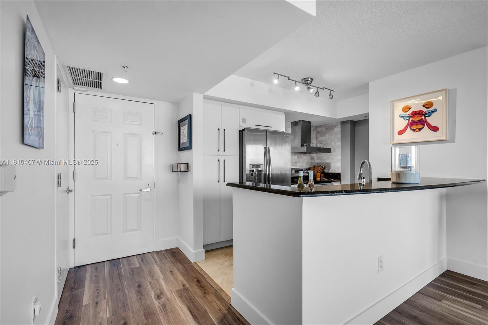 3232 Southwest 22nd Terrace, Unit 1106 Miami, FL 33145 - Photo 5 of 22 a view of kitchen with stainless steel appliances granite countertop a sink and a refrigerator