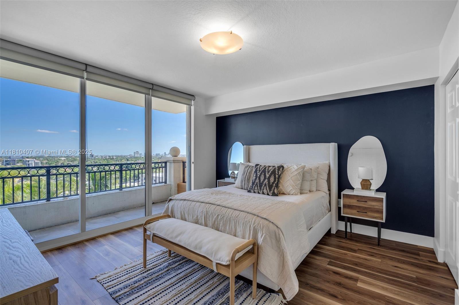 3232 Southwest 22nd Terrace, Unit 1106 Miami, FL 33145 - Photo 8 of 22 a bedroom with a bed lamps and a large window