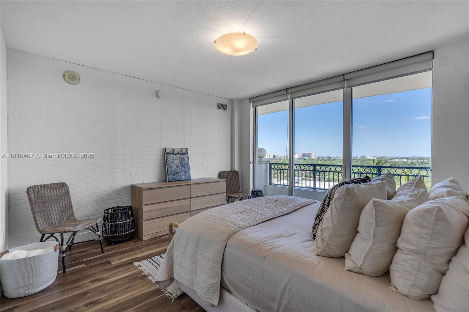 3232 Southwest 22nd Terrace, Unit 1106 Miami, FL 33145 - Photo 9 of 22 a bedroom with a bed and a chair