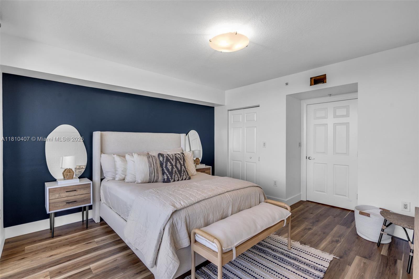 3232 Southwest 22nd Terrace, Unit 1106 Miami, FL 33145 - Photo 10 of 22 a bedroom with a bed and a potted plant