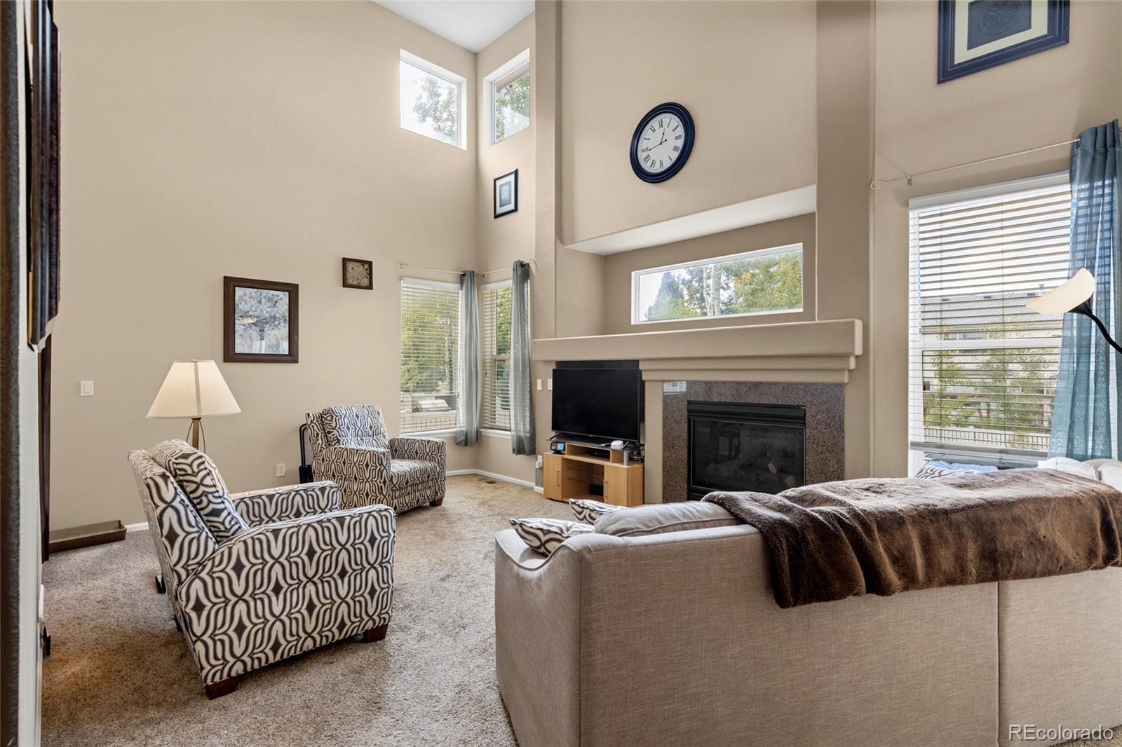 10245 Dusk Street Firestone, CO 80504 - Photo 12 of 24 a living room with furniture fireplace and window