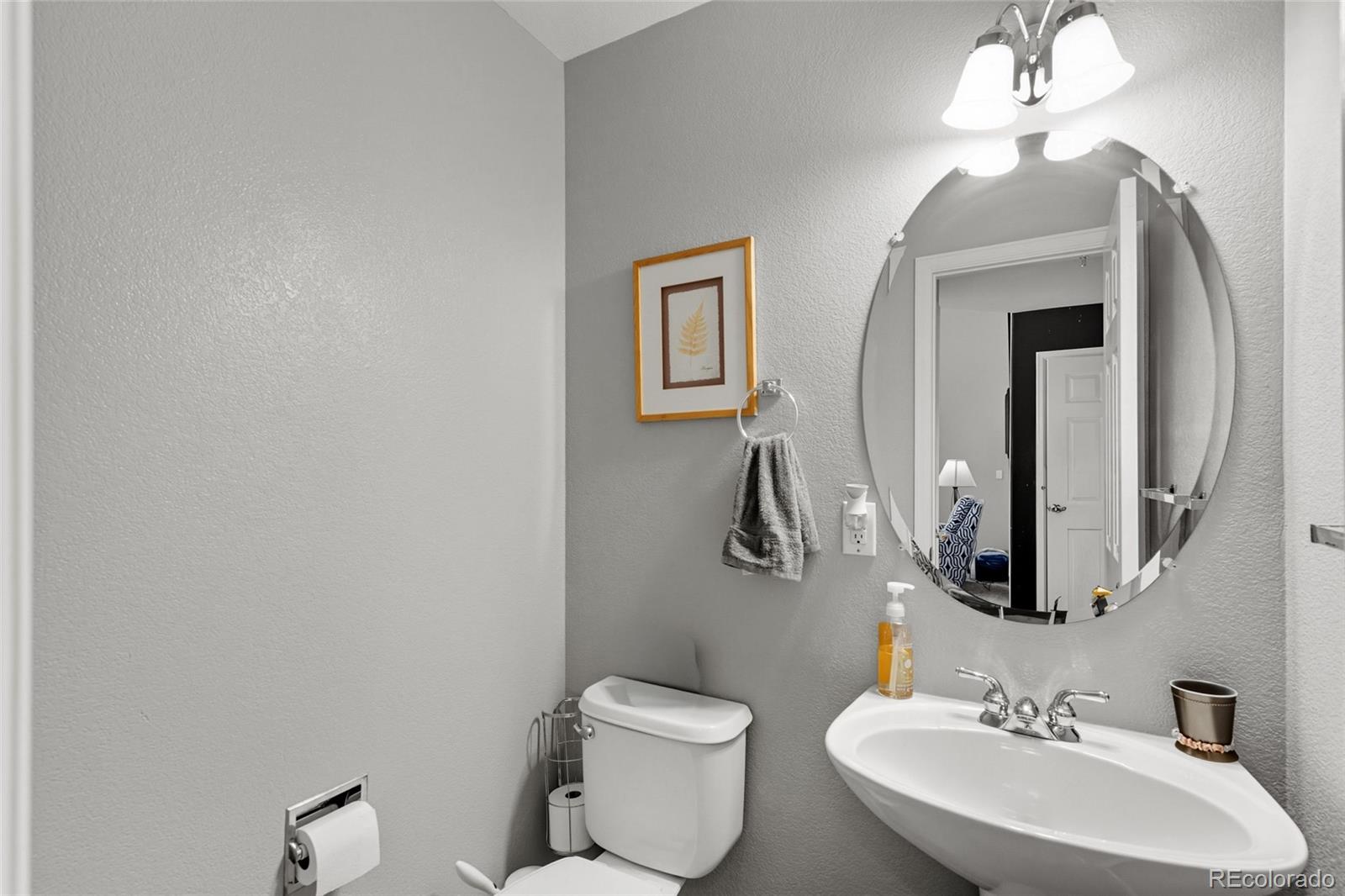 10245 Dusk Street Firestone, CO 80504 - Photo 13 of 24 a bathroom with a toilet a sink and mirror