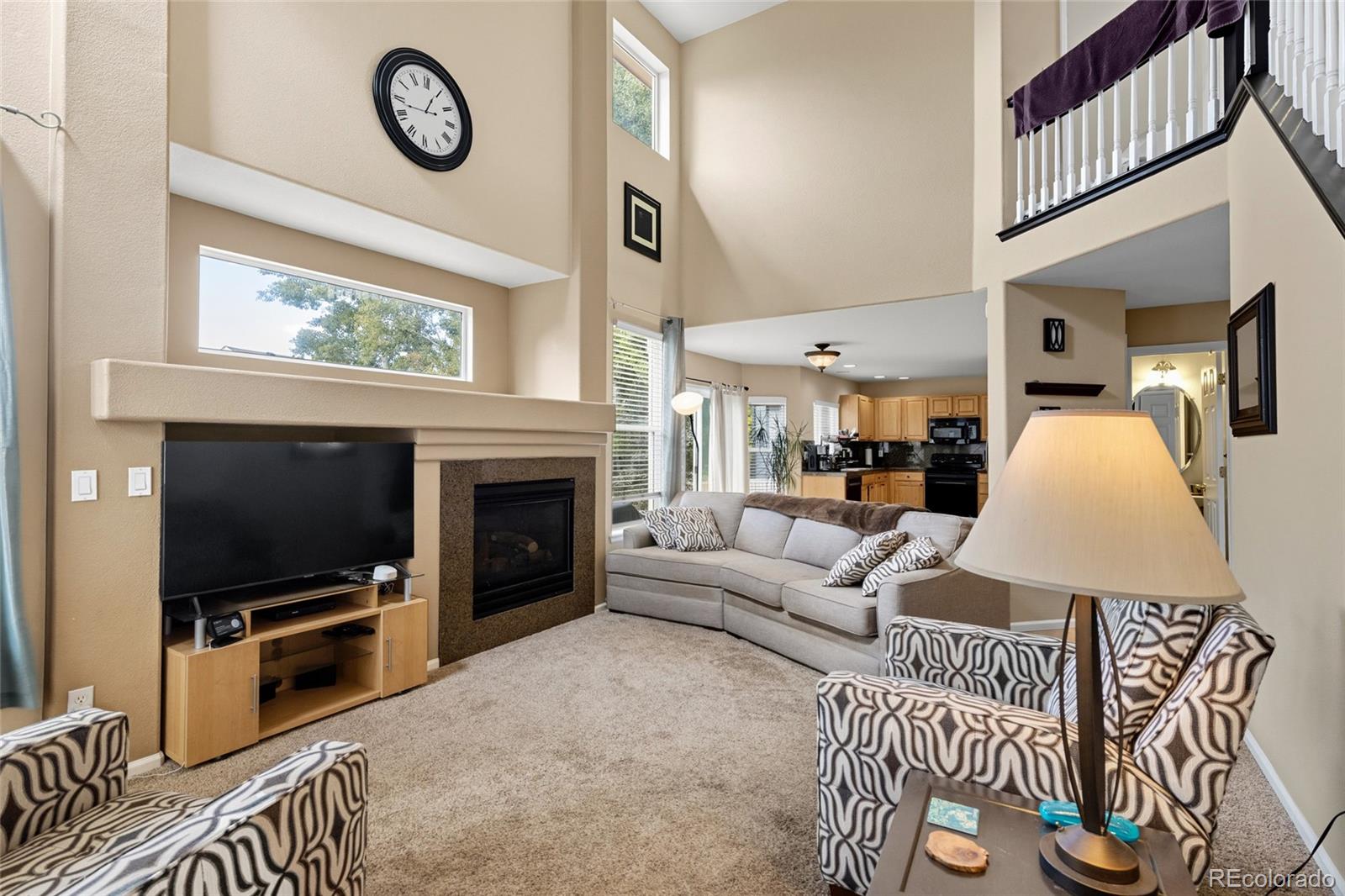 10245 Dusk Street Firestone, CO 80504 - Photo 14 of 24 a living room with furniture a flat screen tv and a fireplace