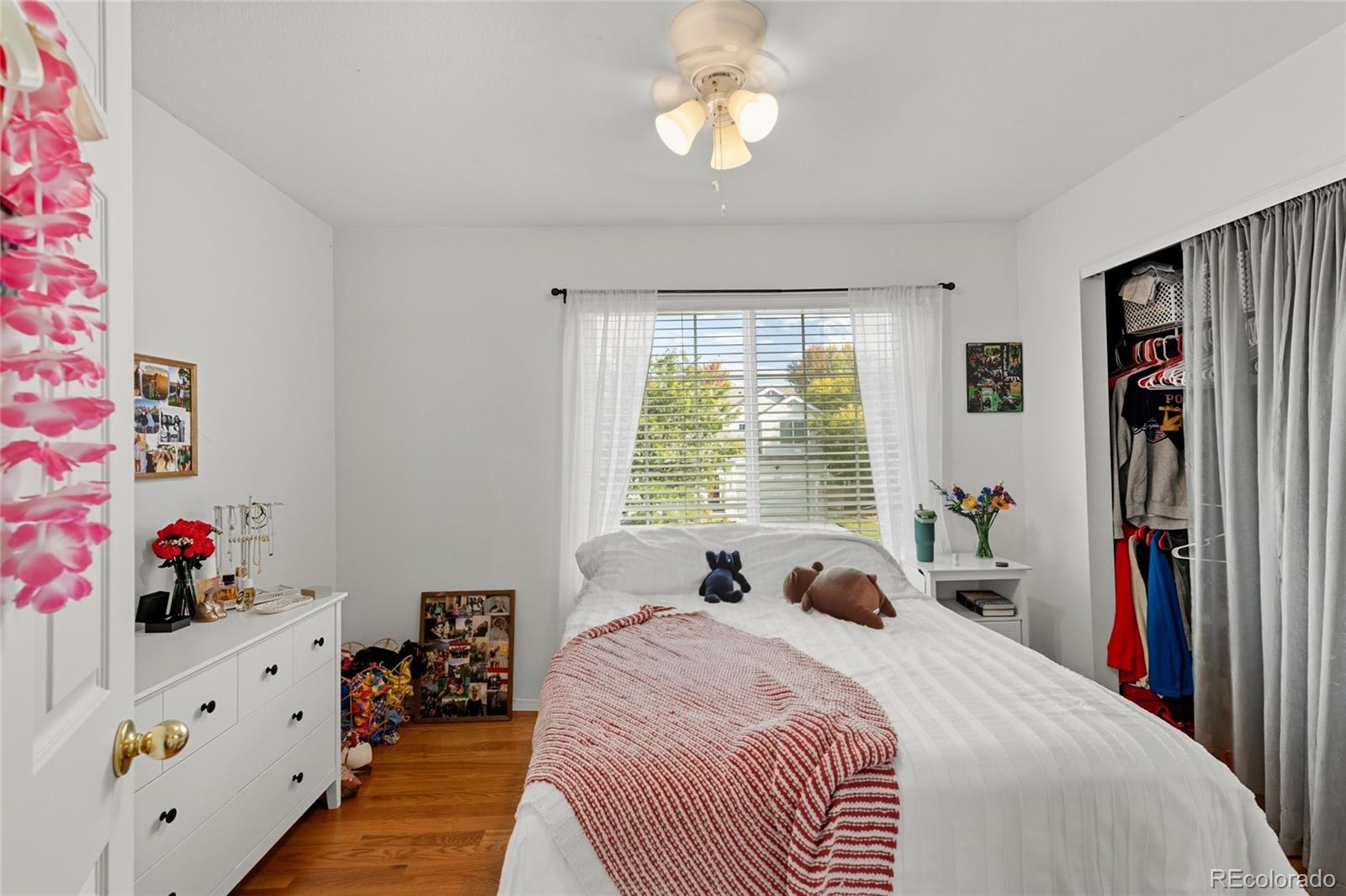 10245 Dusk Street Firestone, CO 80504 - Photo 23 of 24 a bedroom with a bed dresser and a window