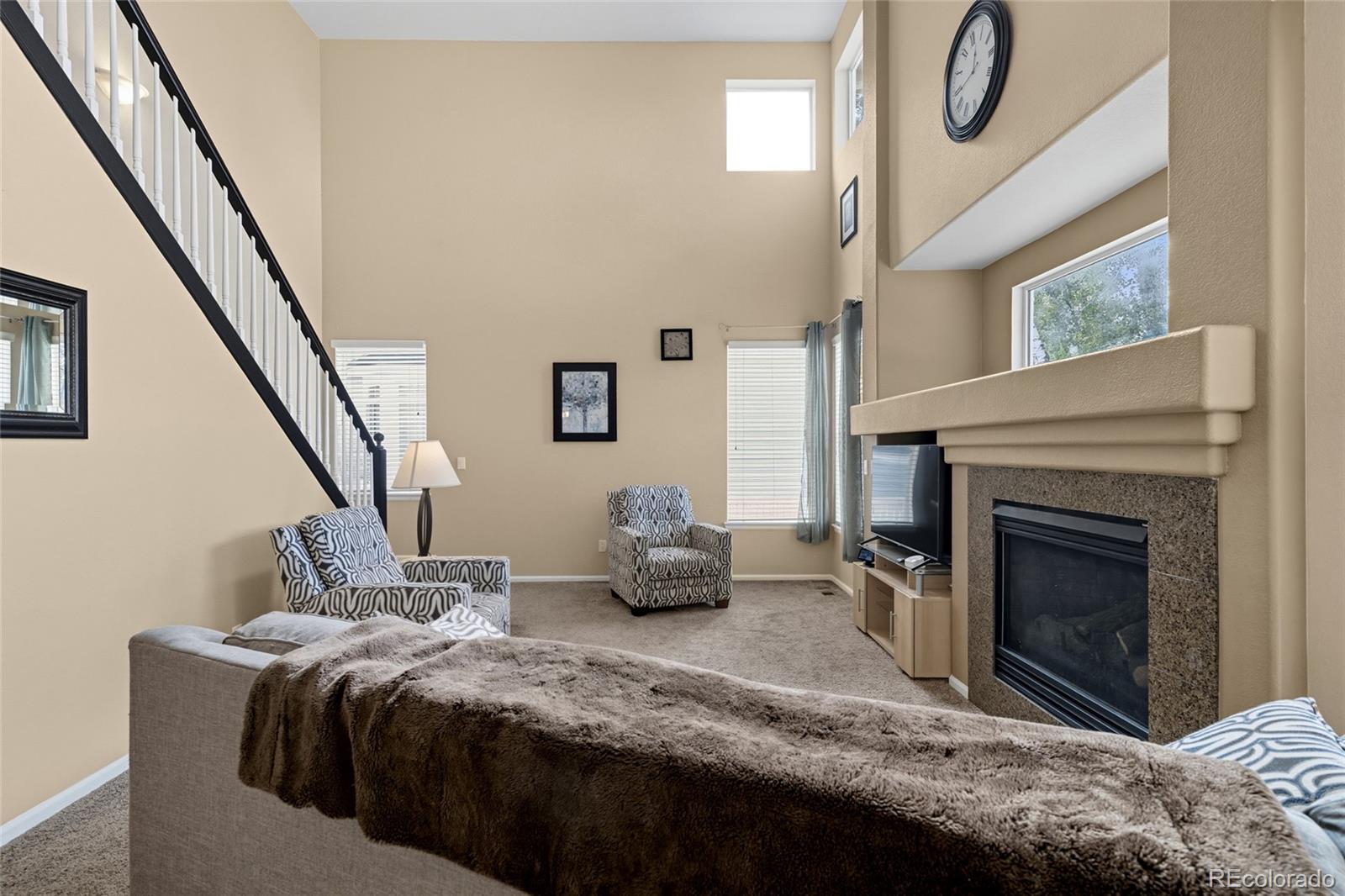 10245 Dusk Street Firestone, CO 80504 - Photo 9 of 24 a bedroom with a bed and a fireplace