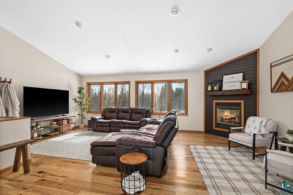 2783 Lauren Road Duluth, MN 55804 - Photo 16 of 47 Living room with a fireplace and light wood-style flooring