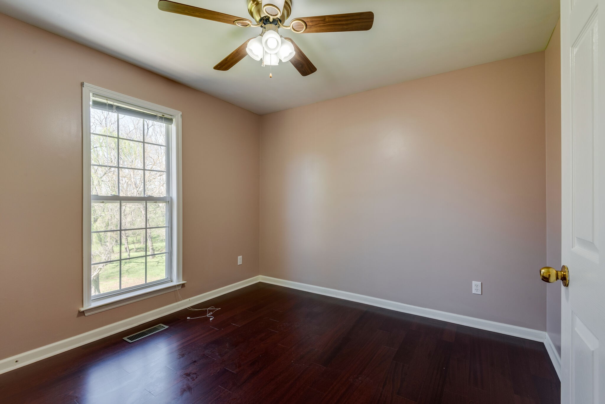 828 Rands Way Columbia, TN 38401 - Photo 14 of 30 an empty room with wooden floor fan and windows