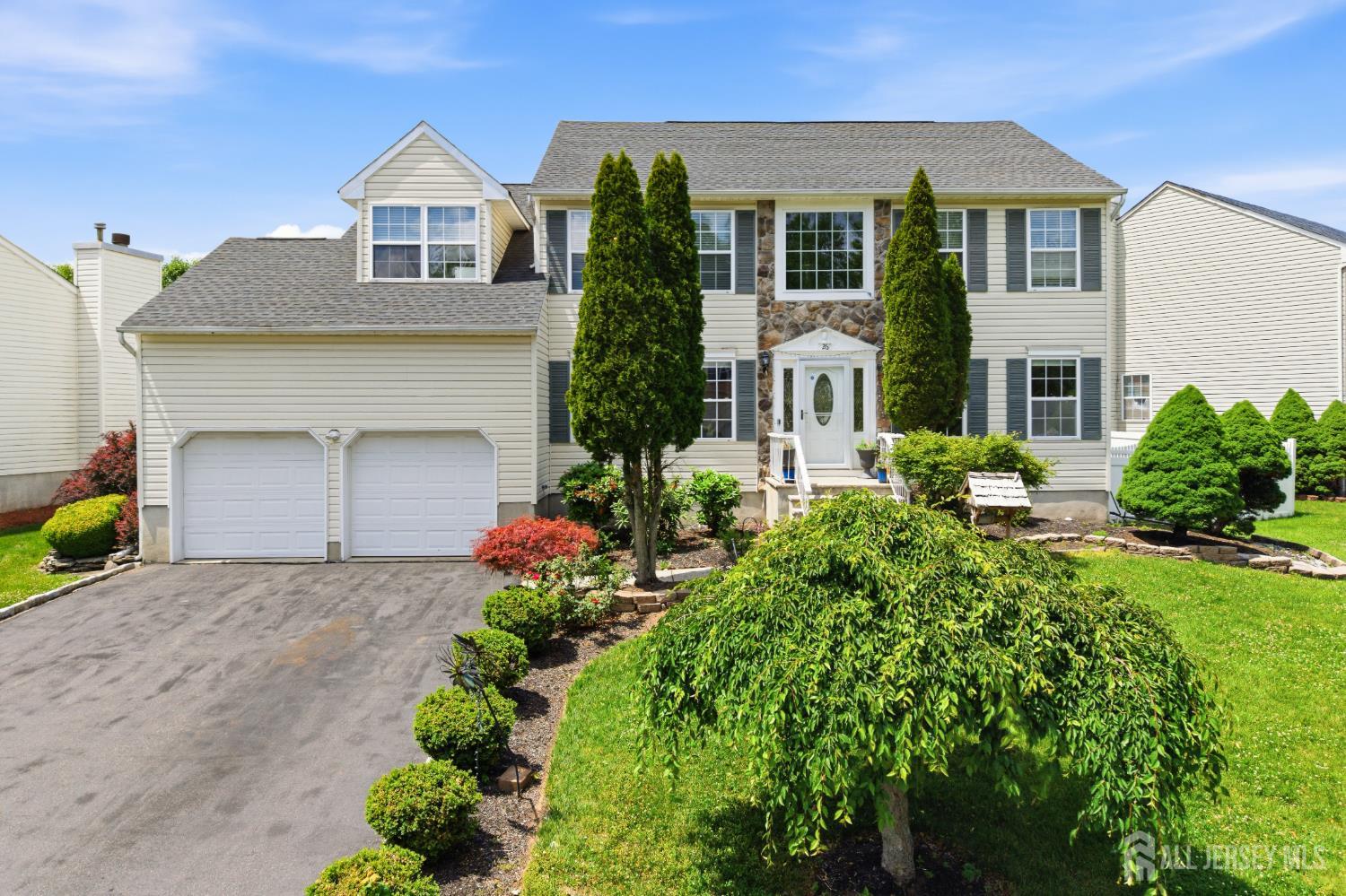 a front view of a house with a yard and garage
