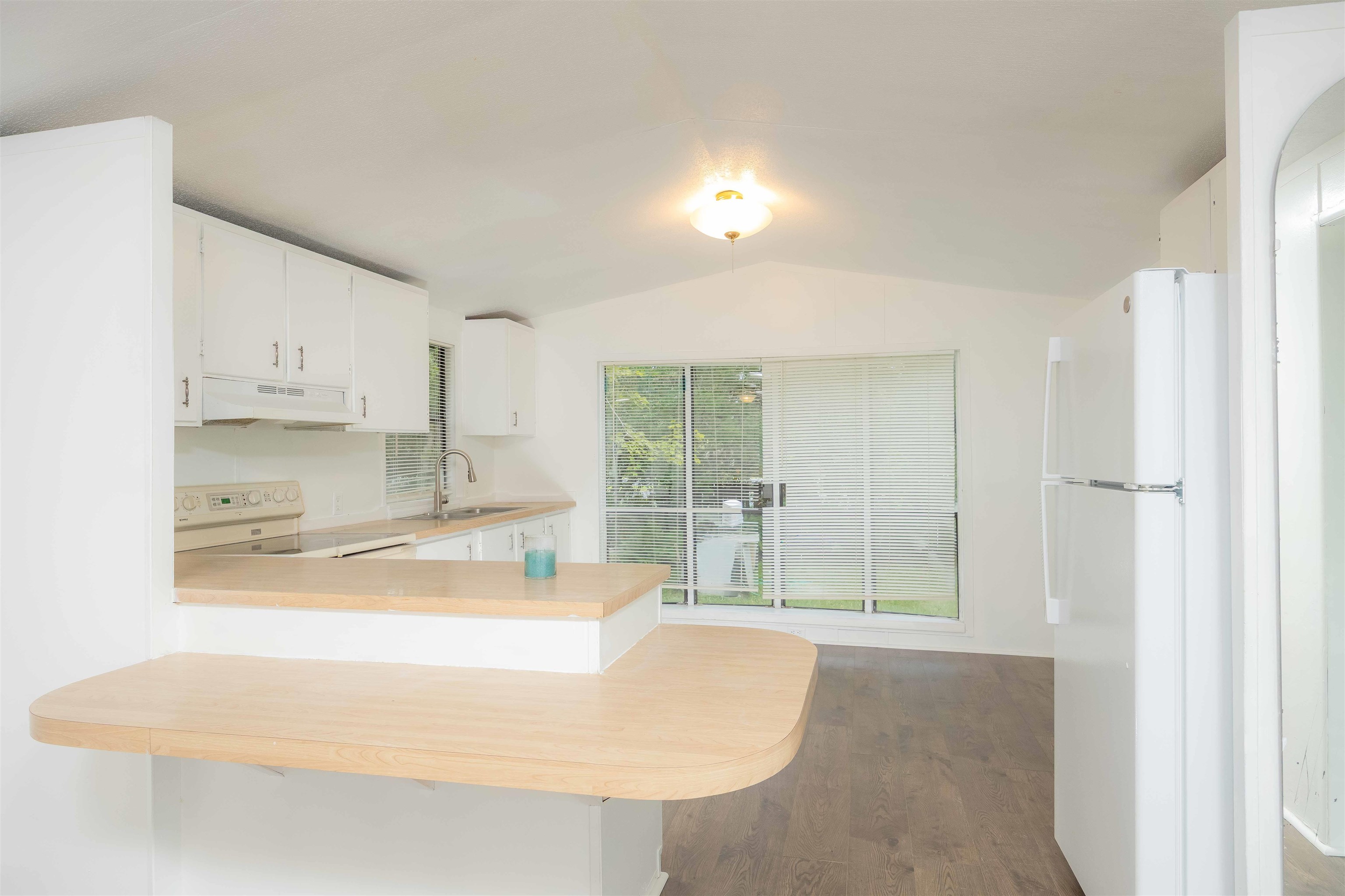 7553 U.S. Rte 1 St. Augustine, FL 32086 - Photo 7 of 16 a large white kitchen with kitchen island a sink a stove and a refrigerator