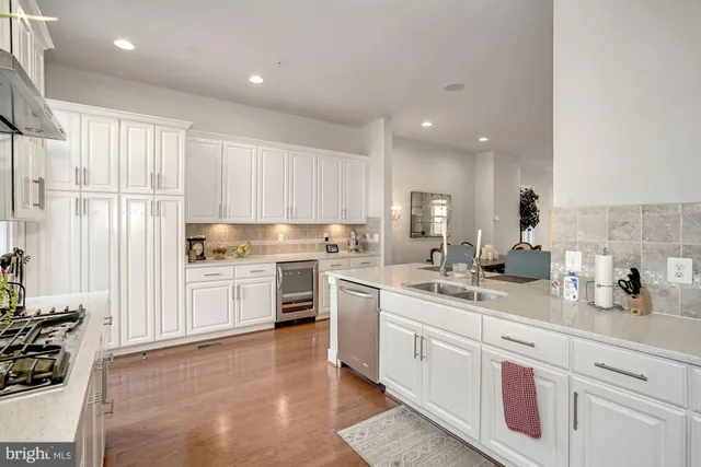 a kitchen with a sink stove cabinets and refrigerator
