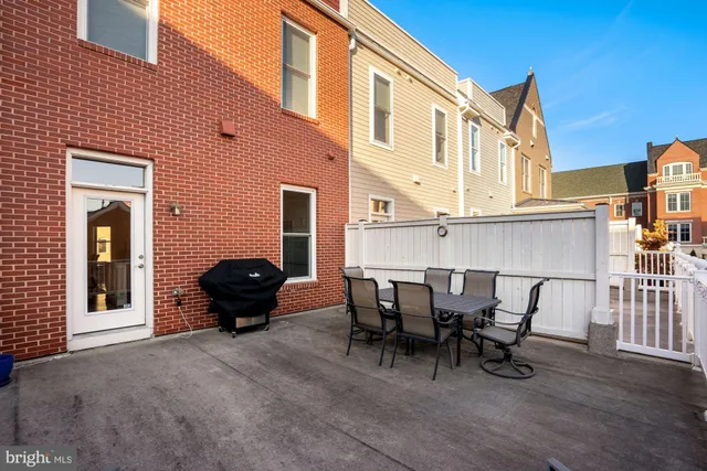 a view of a patio with table and chairs and wooden floor