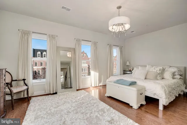 a living room with furniture and a large mirror