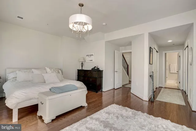 a living room with a bed furniture and a flat screen tv