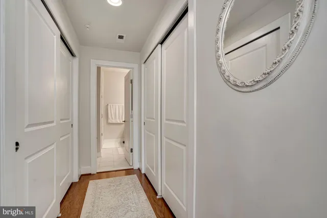 a view of a hallway with wooden floor and entryway