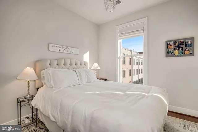 a bedroom with a bed and a lamp