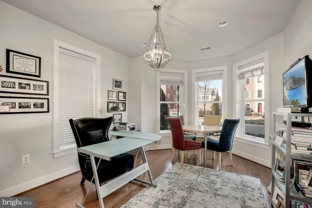a living room with furniture a rug and a chandelier