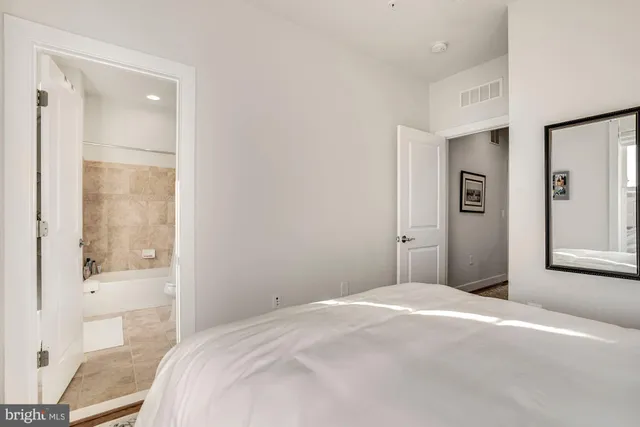 a bedroom with a bed and a large window