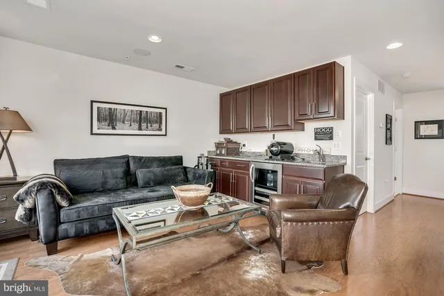 a living room with furniture and kitchen view