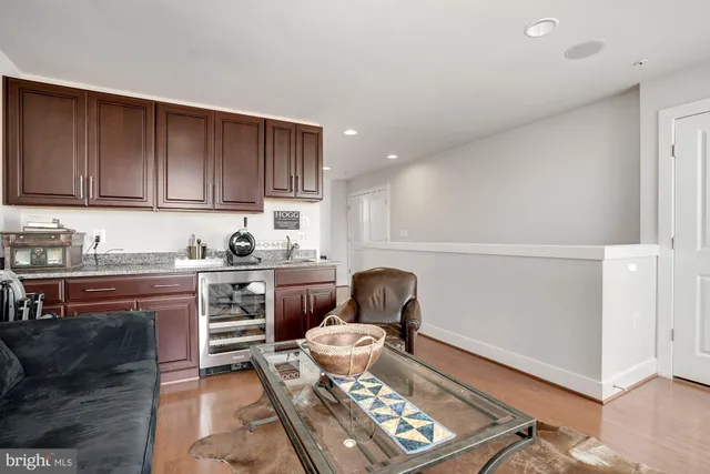 a kitchen with a refrigerator and a stove top oven