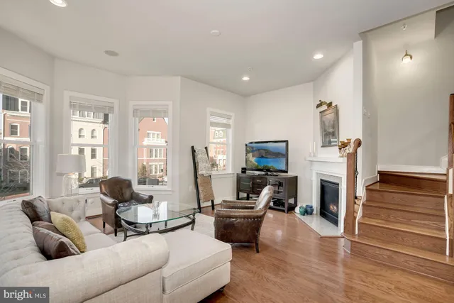 a living room with furniture flat screen tv and a fireplace