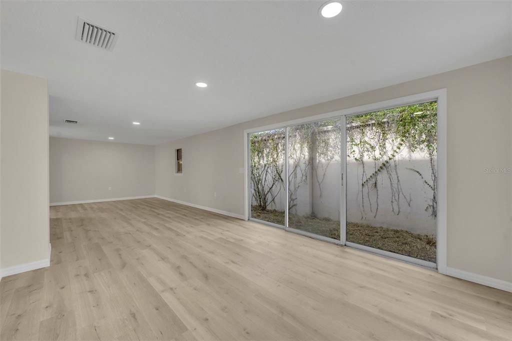31201 Merry Road Tavares, FL 32778 - Photo 12 of 40 wooden floor in an empty room with a window