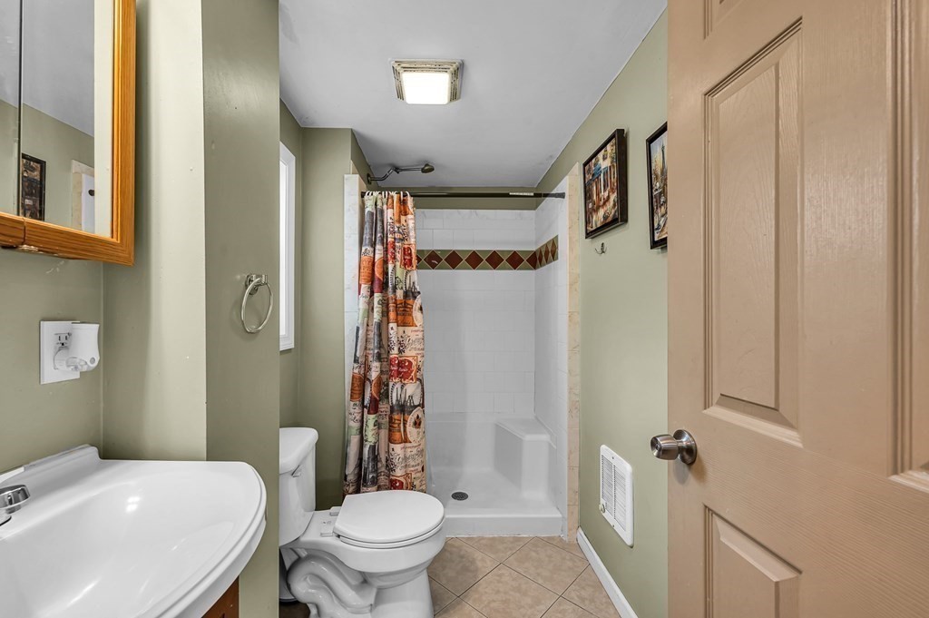 192 Allen Street Springfield, MA 01108 - Photo 15 of 35 a bathroom with a sink toilet and shower