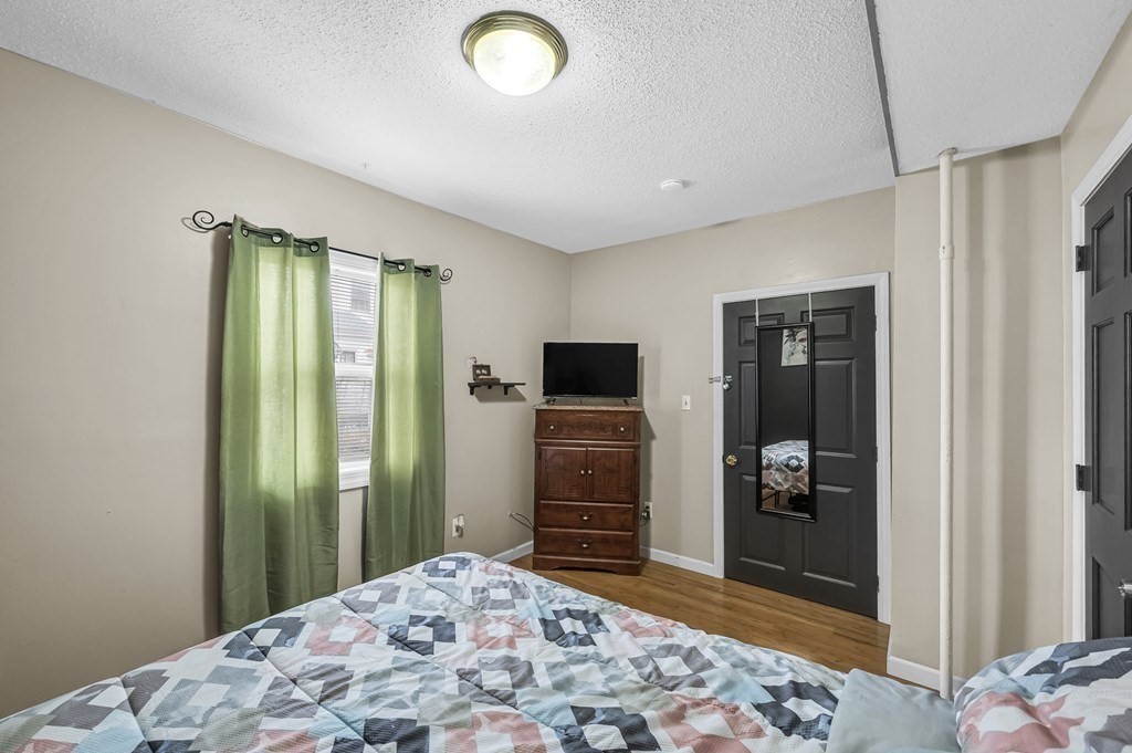 192 Allen Street Springfield, MA 01108 - Photo 16 of 35 a bedroom with a bed and a mirror