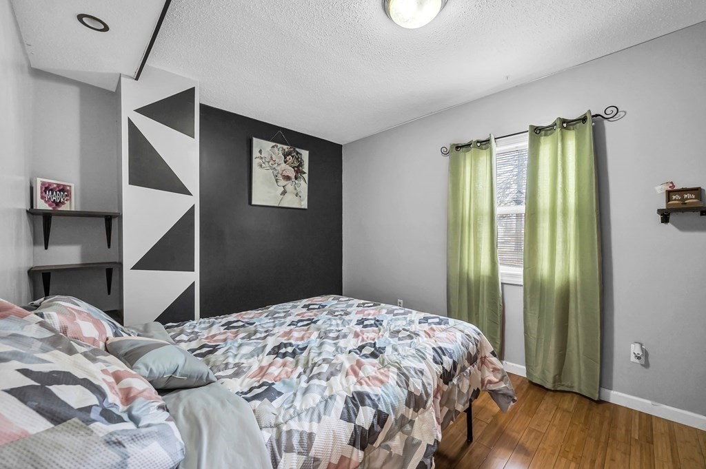 192 Allen Street Springfield, MA 01108 - Photo 17 of 35 a bedroom with a bed and a chandelier