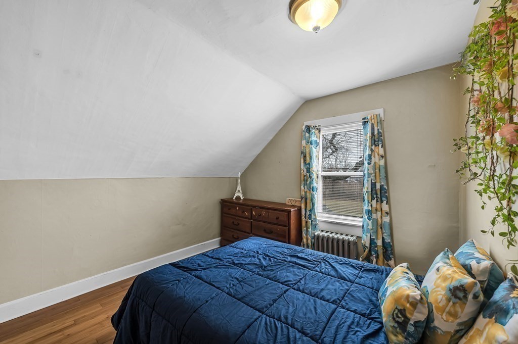 192 Allen Street Springfield, MA 01108 - Photo 21 of 35 a bedroom with a bed and wooden floor