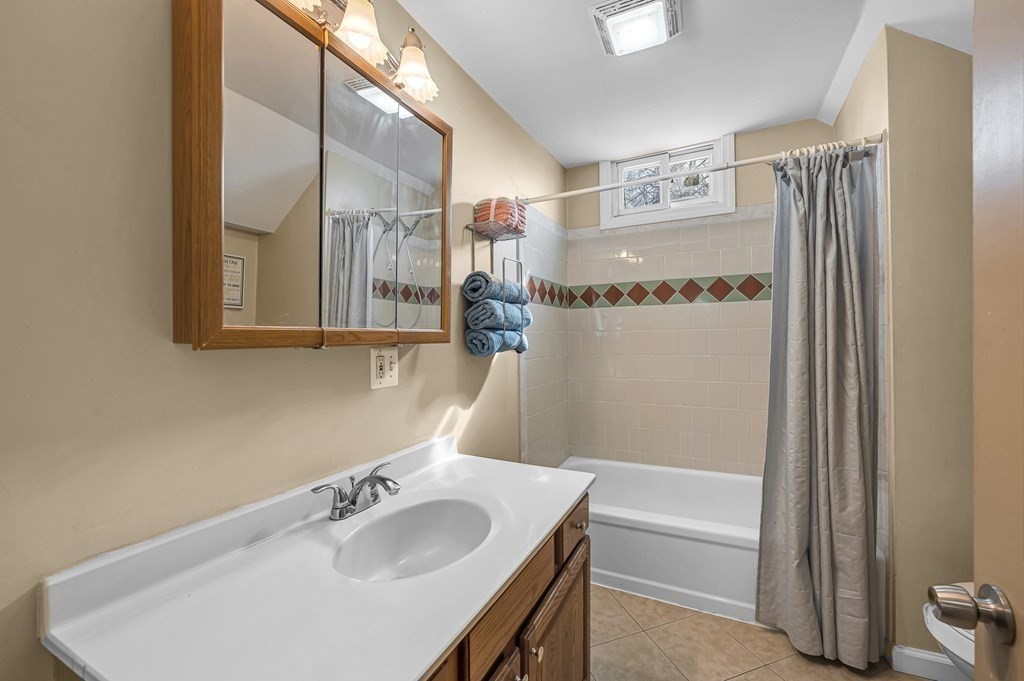 192 Allen Street Springfield, MA 01108 - Photo 23 of 35 a bathroom with a granite countertop sink and a mirror