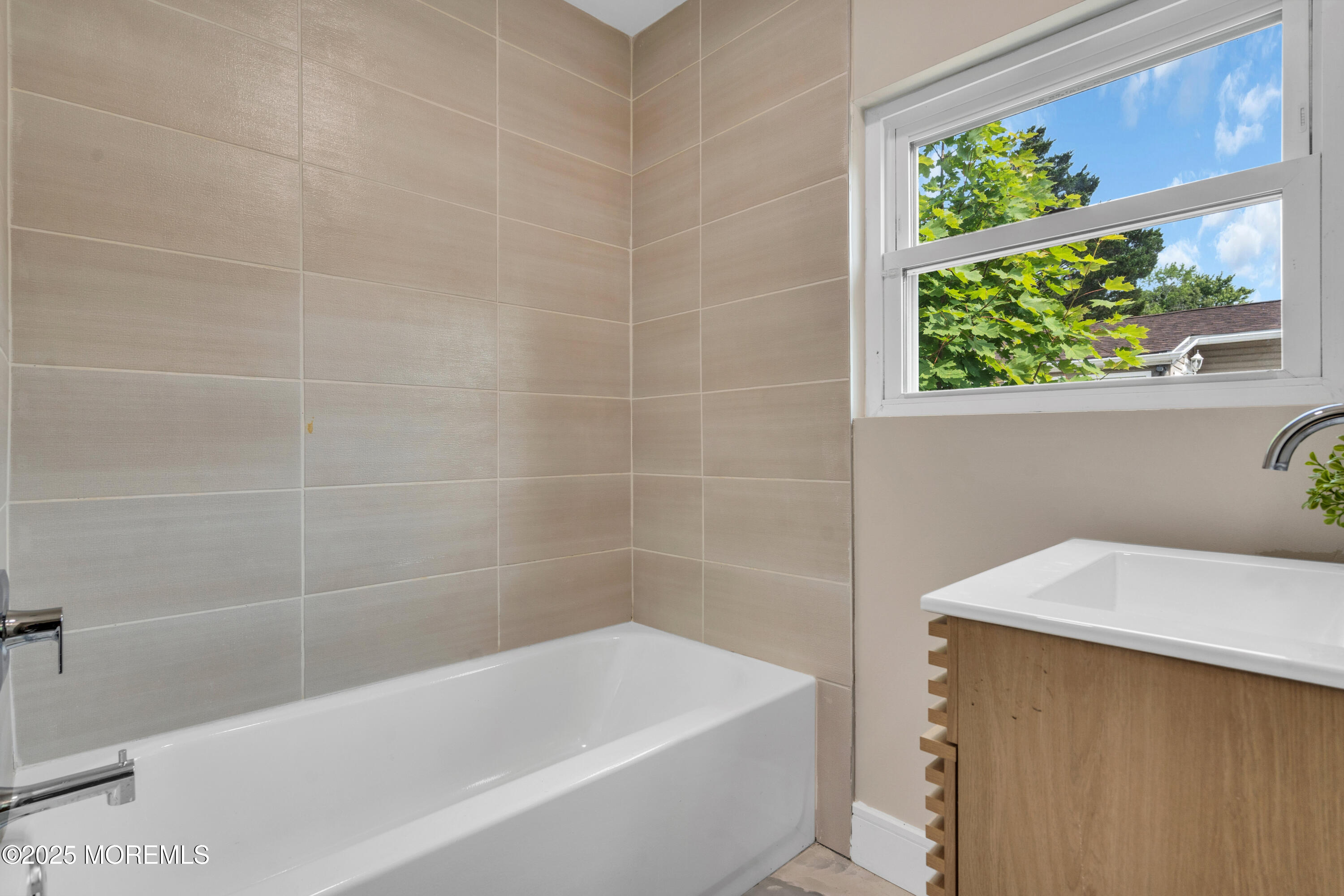 882 Radio Road Little Egg Harbor, NJ 08087 - Photo 18 of 24 a bathroom with a bathtub a window and a shower