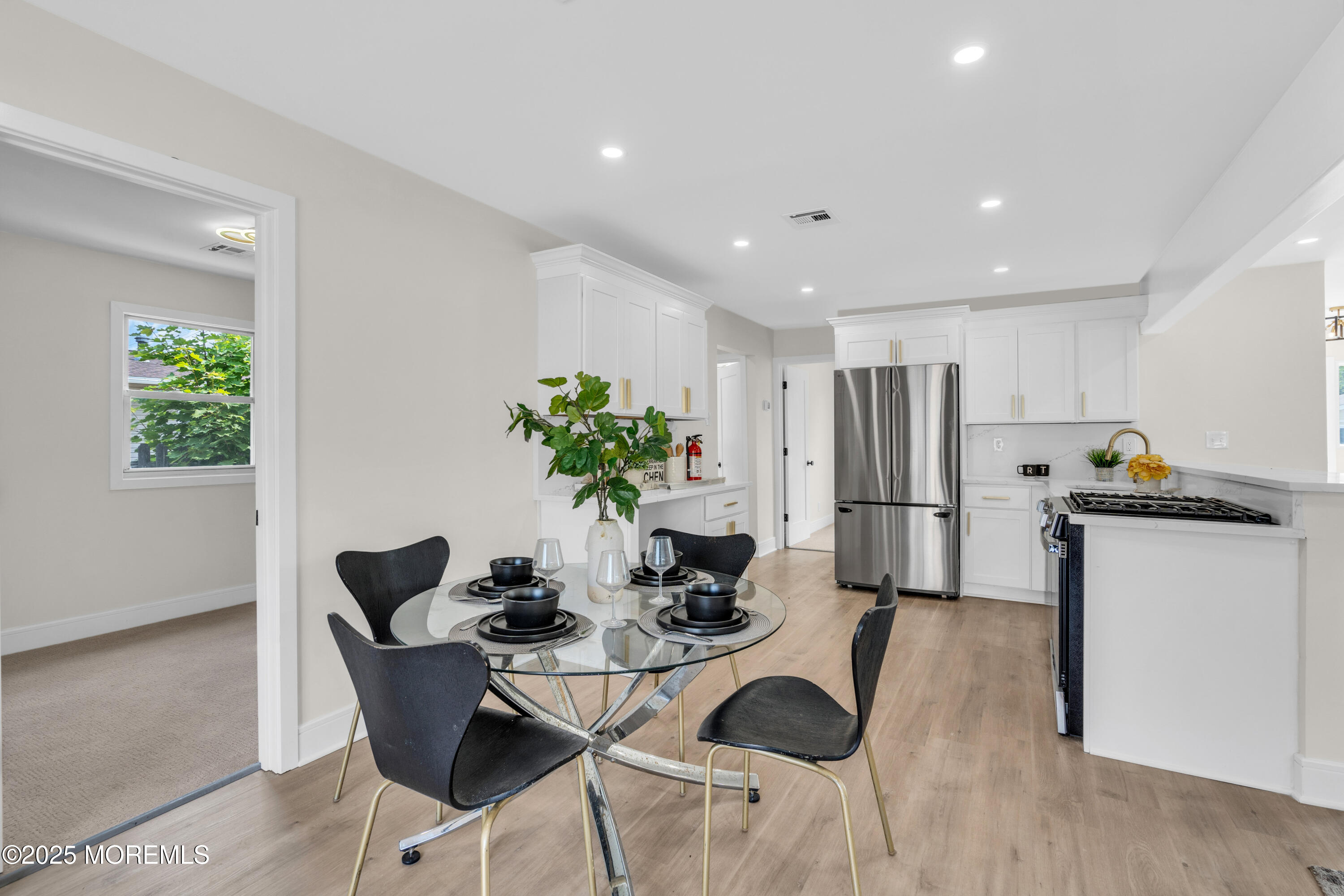 882 Radio Road Little Egg Harbor, NJ 08087 - Photo 9 of 24 a kitchen with a dining table cabinets and stainless steel appliances