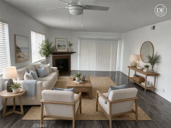 a living room with furniture a fireplace and a dining table with wooden floor