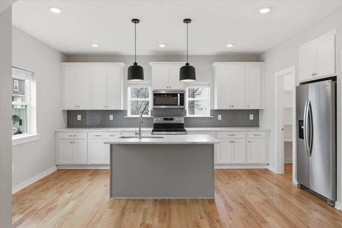 109 A Duke Street Nashville, TN 37207 - Photo 7 of 21 a kitchen with stainless steel appliances granite countertop a stove a sink and a refrigerator