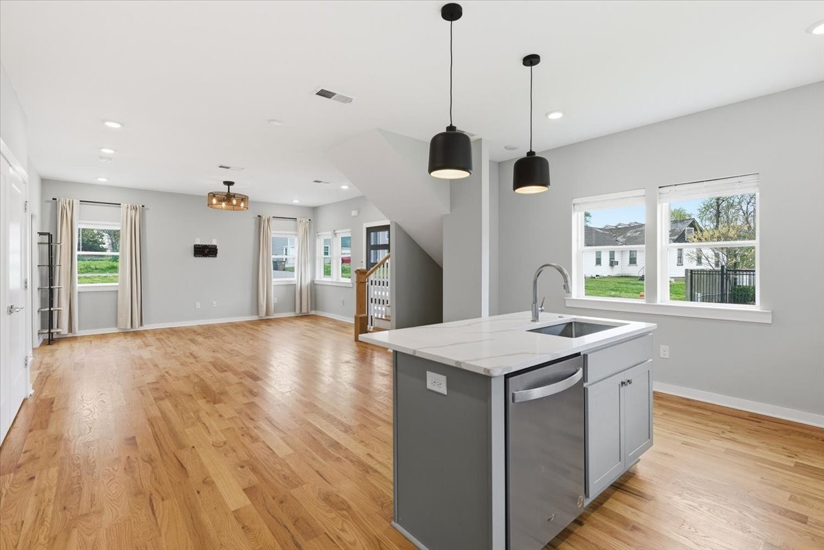 109 A Duke Street Nashville, TN 37207 - Photo 10 of 21 a kitchen with a stove center island wooden floor and a ceiling fan
