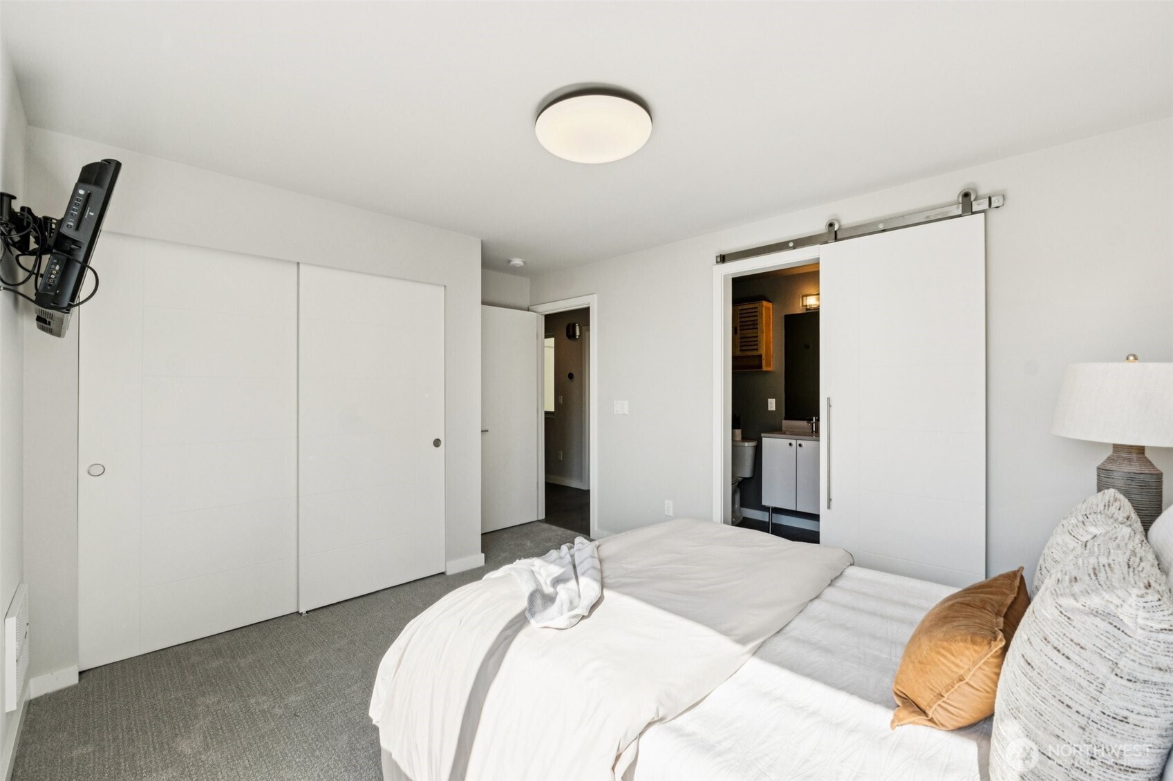 2653 Northwest 64th Street, Unit A Seattle, WA 98107 - Photo 12 of 22 a bedroom with a bed and a lamp