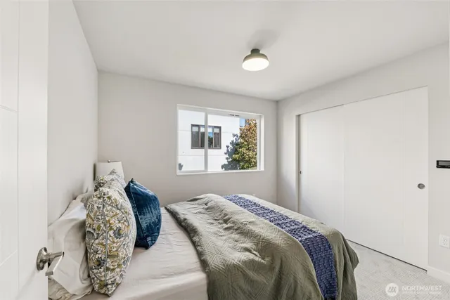 a bedroom with a large bed and a window