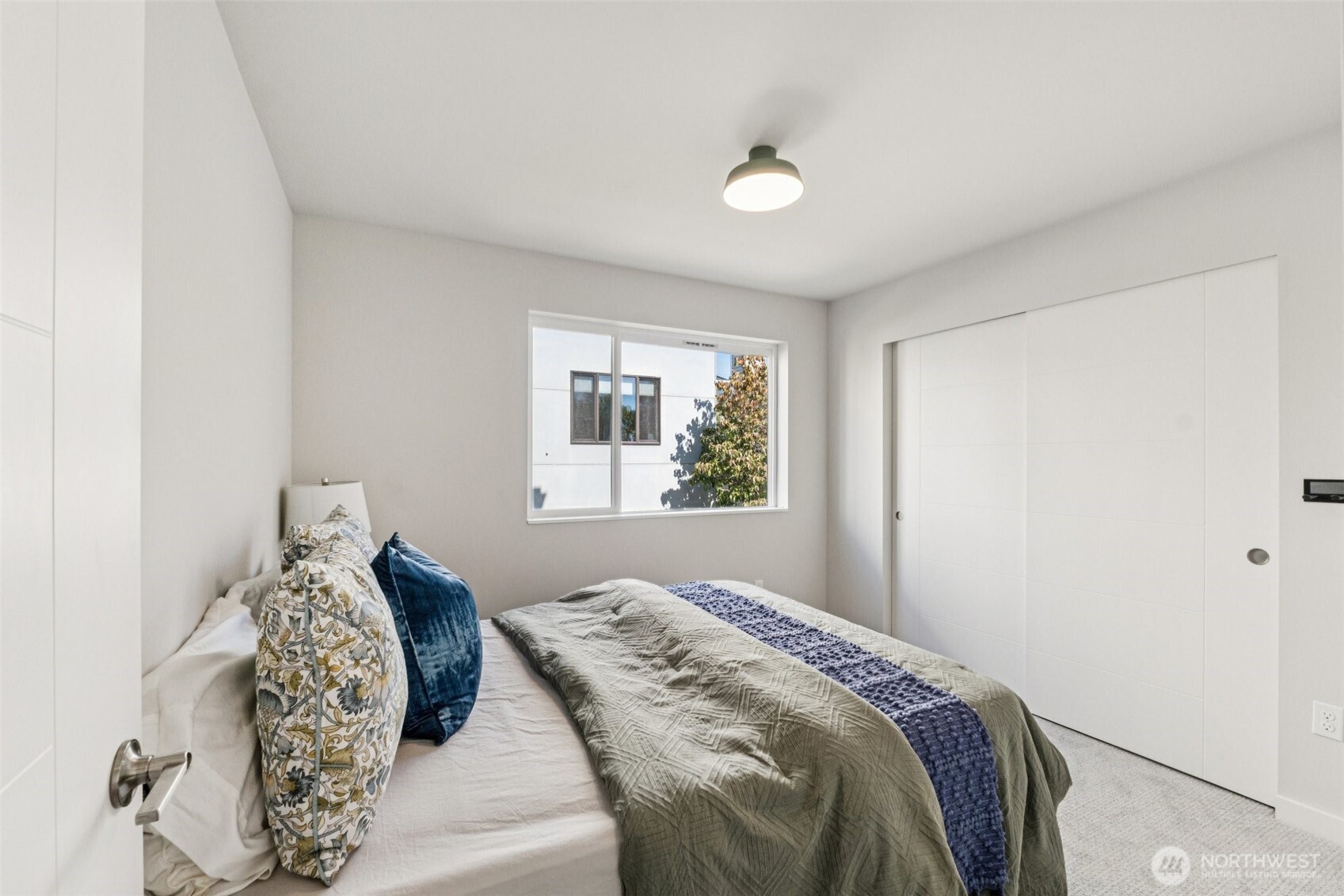 2653 Northwest 64th Street, Unit A Seattle, WA 98107 - Photo 14 of 22 a bedroom with a large bed and a window