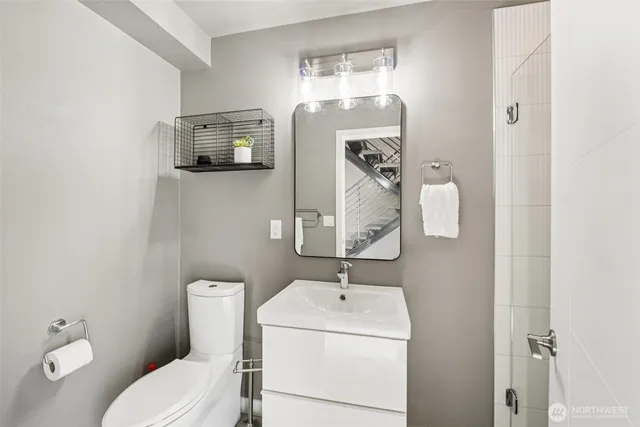 a bathroom with a toilet sink and mirror