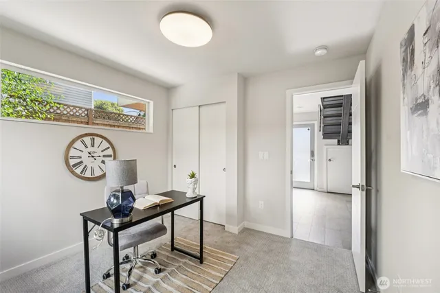 a view of a hallway that has a table and a chair in it