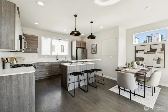 a kitchen with sink cabinets and wooden floor