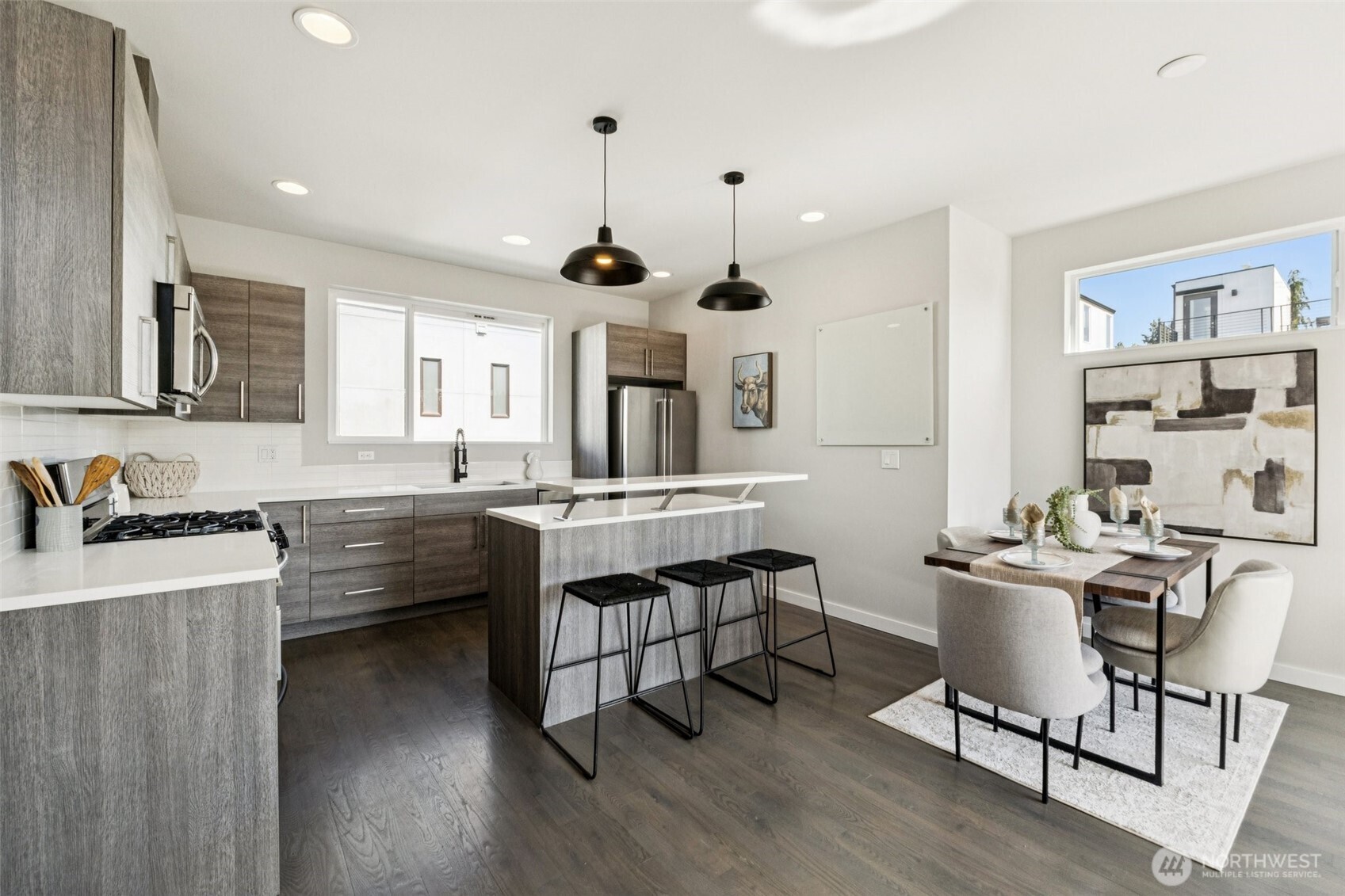 2653 Northwest 64th Street, Unit A Seattle, WA 98107 - Photo 6 of 22 a kitchen with sink cabinets and wooden floor