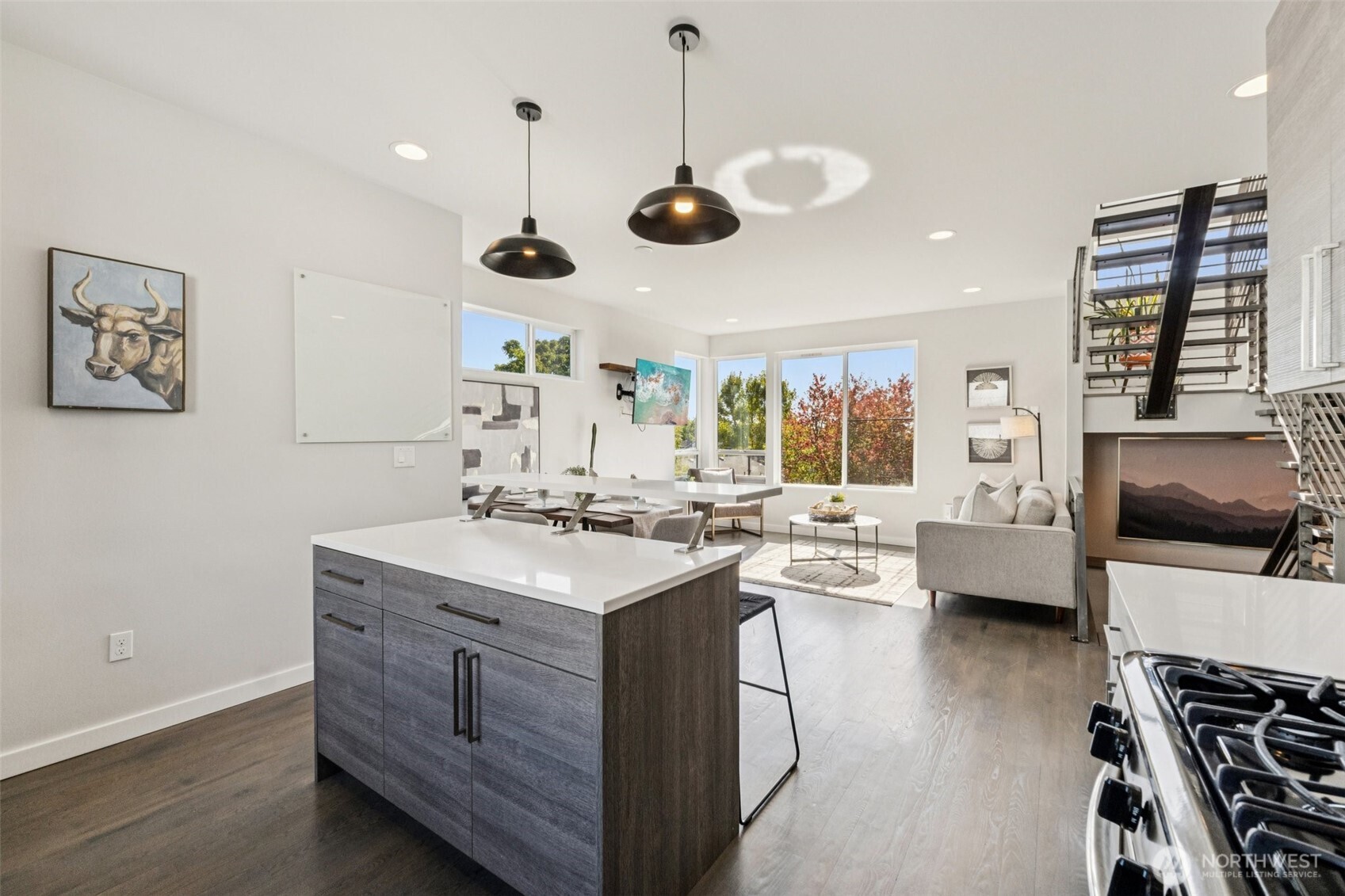 2653 Northwest 64th Street, Unit A Seattle, WA 98107 - Photo 8 of 22 a kitchen with a stove a window and chairs