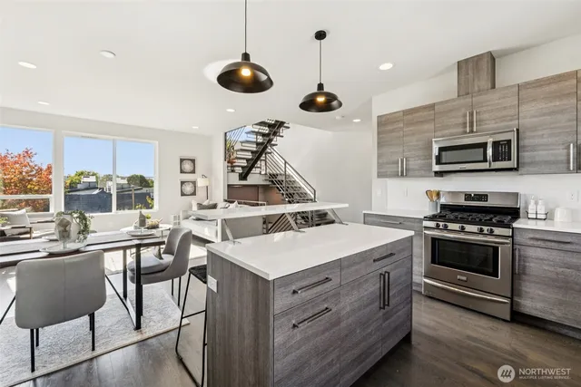 a kitchen with a stove a microwave and a table