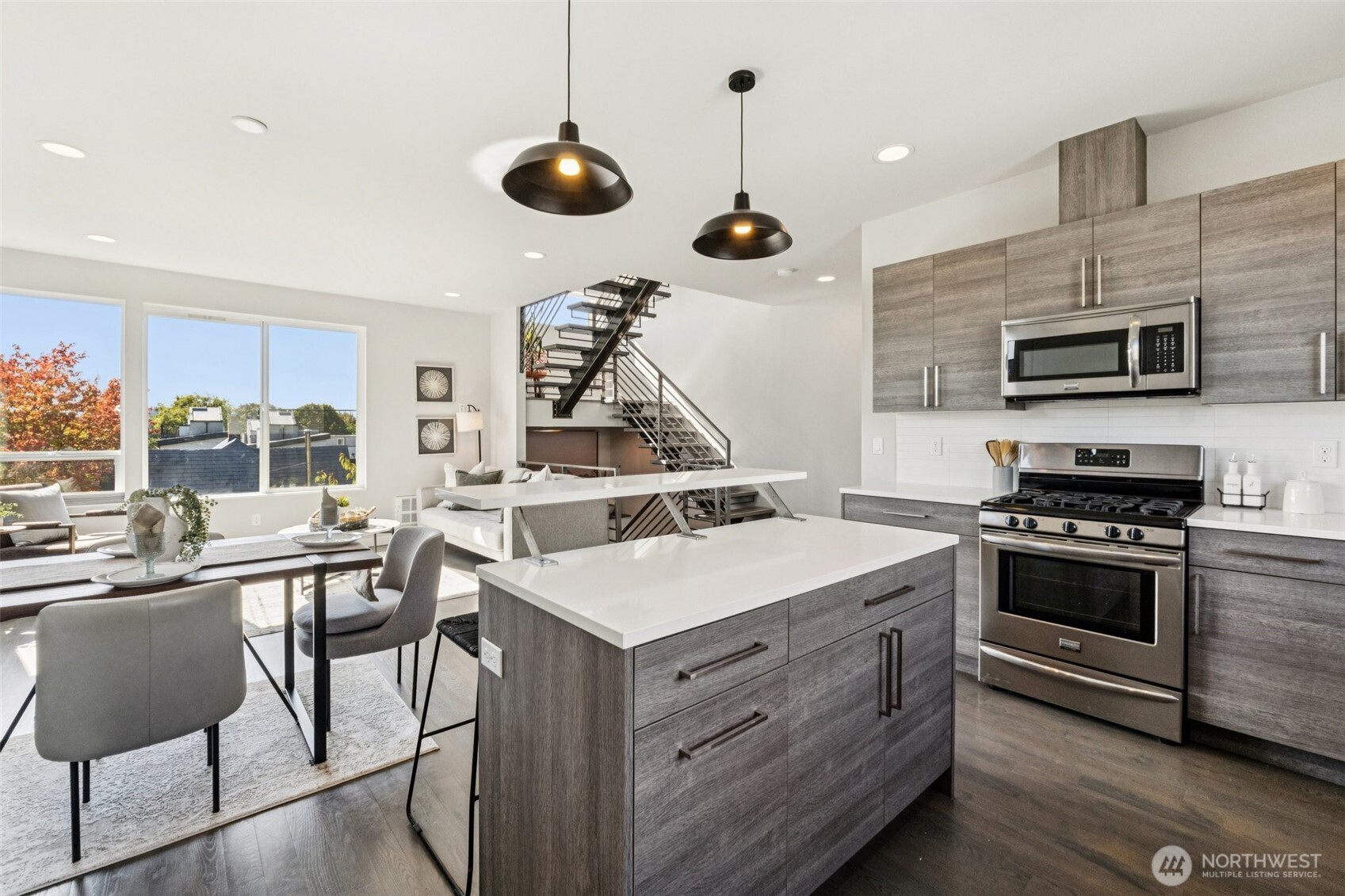 2653 Northwest 64th Street, Unit A Seattle, WA 98107 - Photo 9 of 22 a kitchen with a stove a microwave and a table