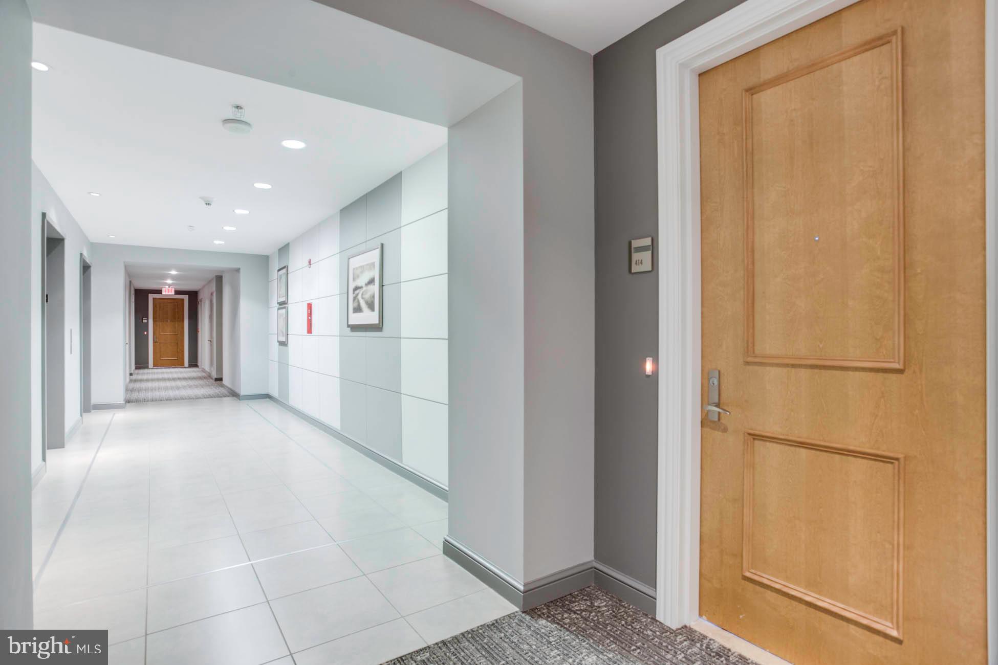 11990 Market Street, Unit 414 Reston, VA 20190 - Photo 17 of 58 Ha;; Entry Door to Elevators