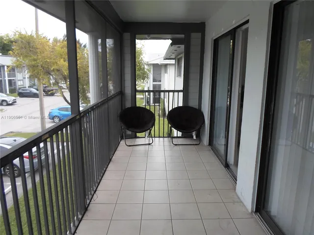 a view of a balcony with chairs