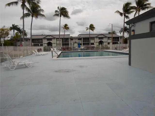 a view of multiple houses with a swimming pool