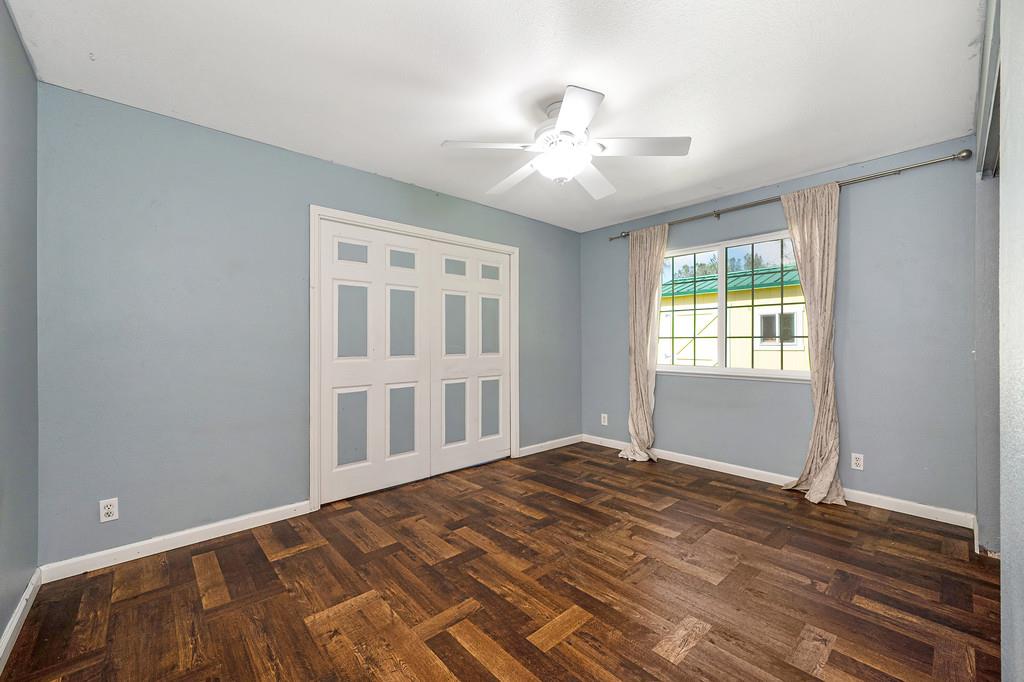 6181 Lambert Lane El Dorado, CA 95623 - Photo 38 of 68 unfurnished bedroom featuring dark wood-type flooring, a closet, and a ceiling fan